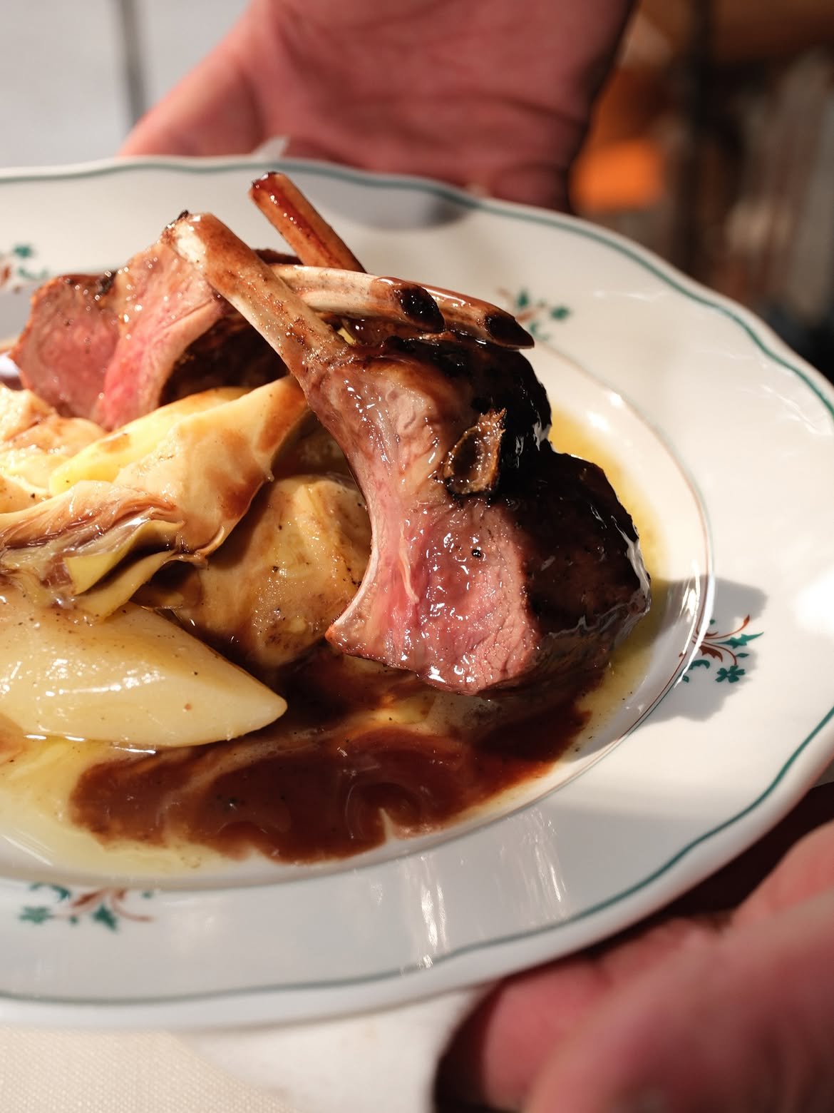 Grilled lamb chops with baked potatoes and artichokes